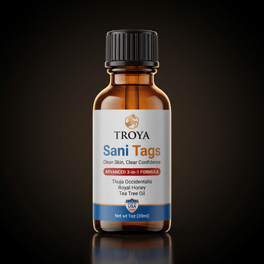 Troya Sani Tags botanical skin serum — amber glass bottle on a dark studio background