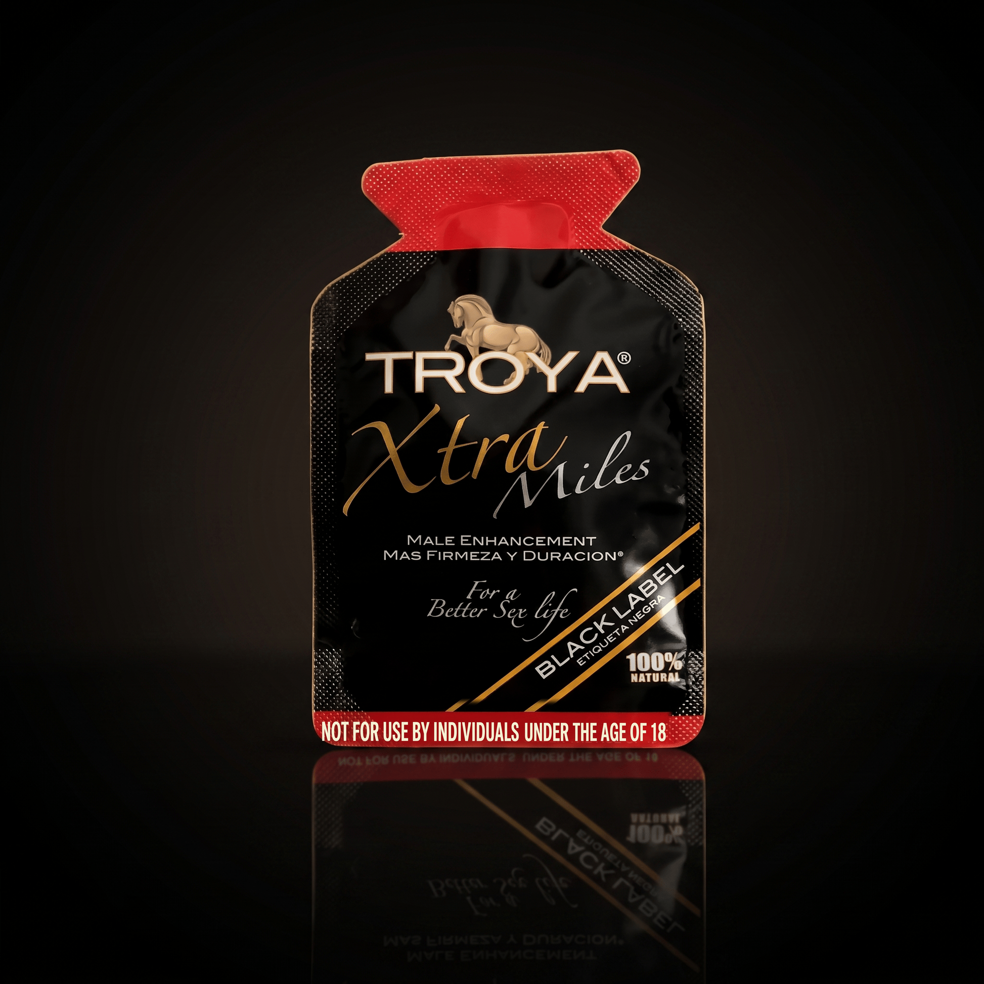 Troya XTRA MILE single-use sachet on a dark studio background